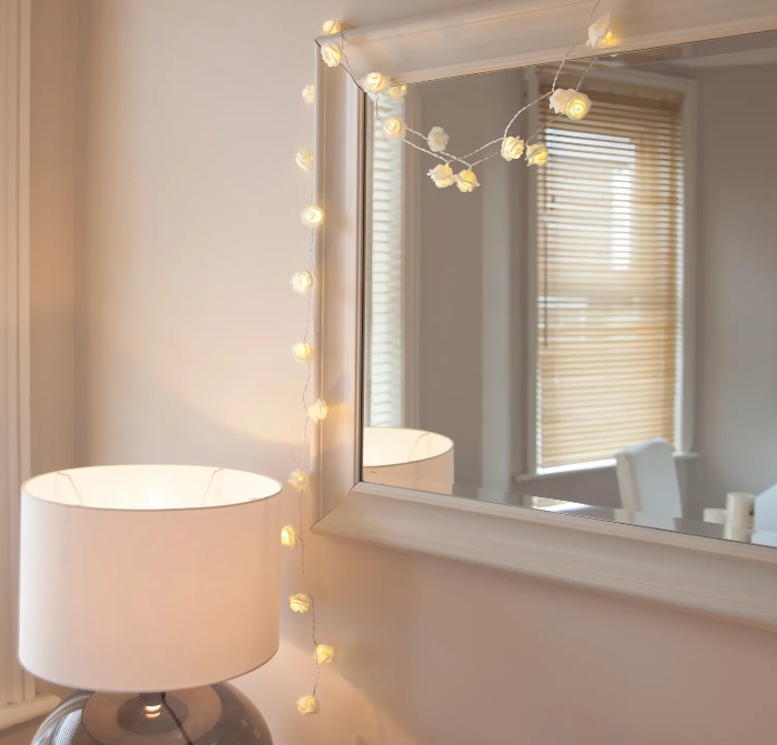 interior decor with delicate round fairy lights around a mirror