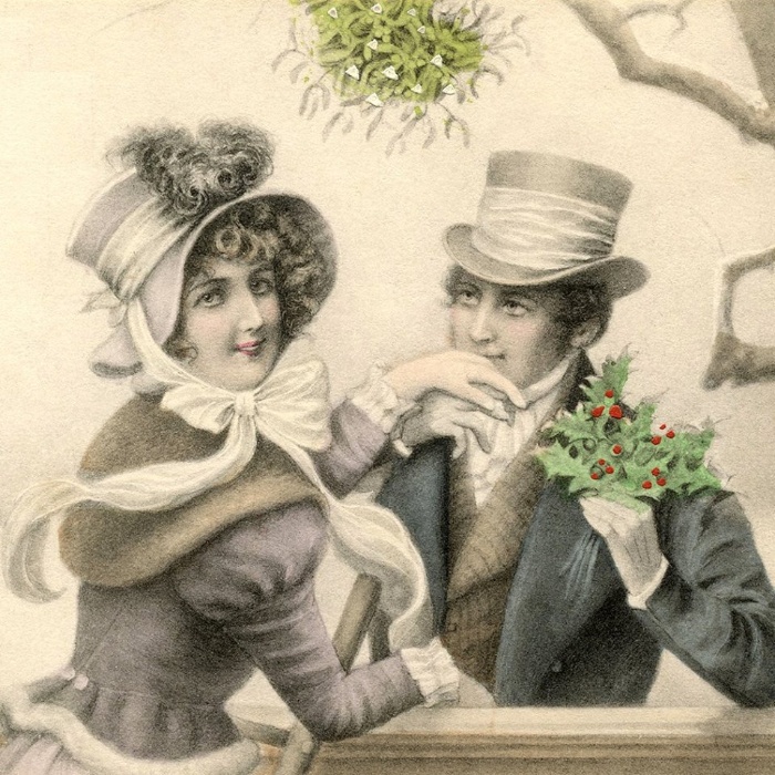 kissing under the mistletoe vinatge card on a couple under the mistletoe
