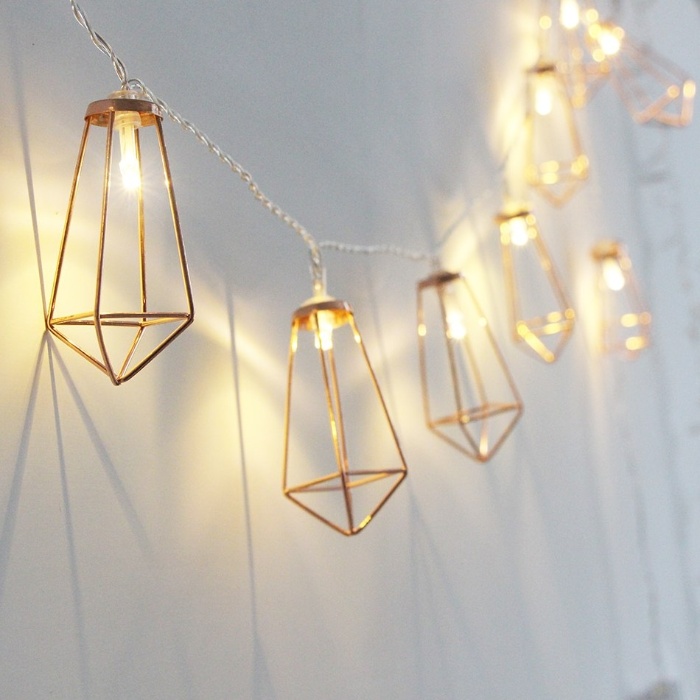 modern fairy lights with metal beams hanging on a clean white wall