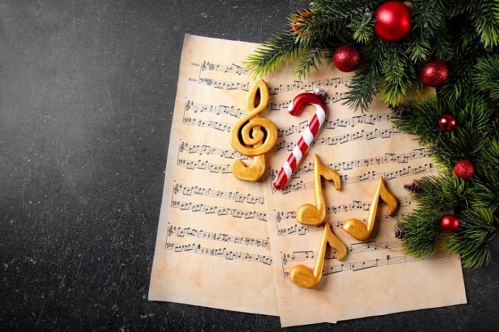 music carols musical notes papers with candy and cookies