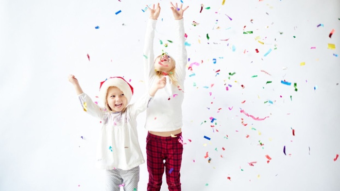 kids on a white background celebrating with colorful confetti