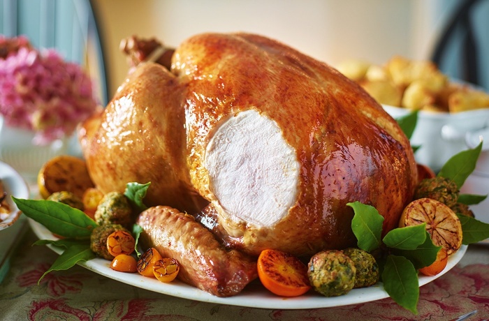 large roasted turkey with vegetables on a decorated table