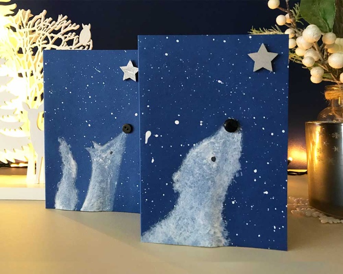 simple christmas cards two blue cards with a wolf and a bear looking at a star