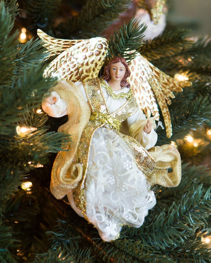 tree ornament angel on a christmas tree dressed in white and gold