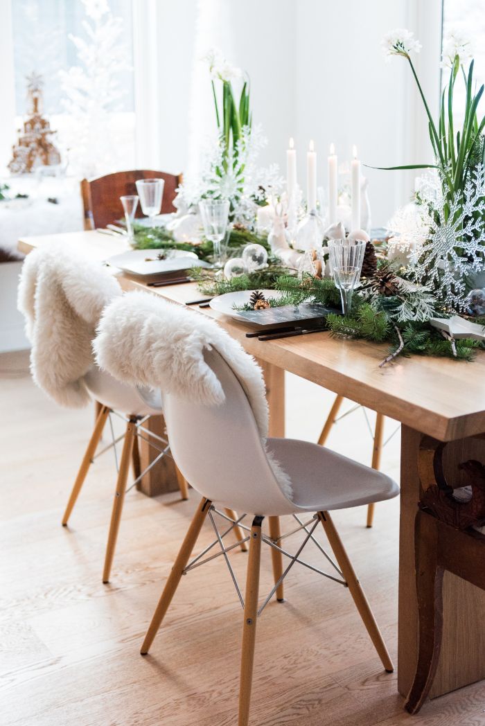 winter decorations wooden table with white chairs fur throws green moss natural decor