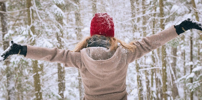 winter wonderland woman in red hat enjoying the snowy landscape