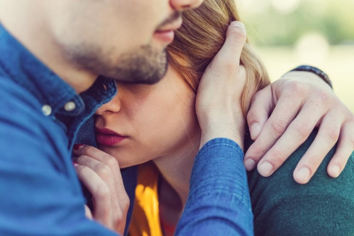 man in a denim shirt hugging a girl 