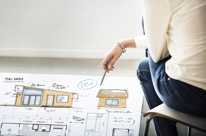 woman sitting on a chair with a design of a home in front of her