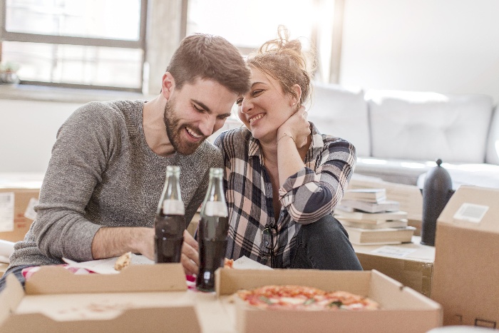 eating together romantic date at home with pizza couple at home