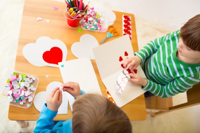 valentine's day with kids two little boys playing with paper hearts