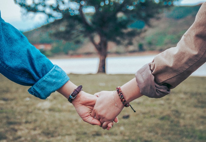 dating during pandemic couple outdoors holding hands