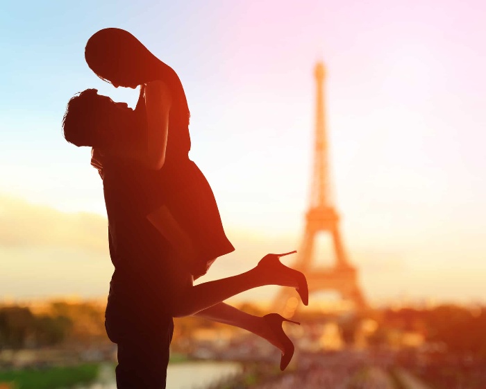 paris love story silhouettes of a couple in front of the Eiffel tower man holding a woman