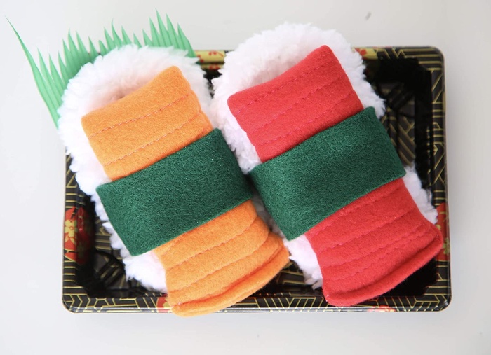 two sushi slippers on a tray red and yellow color