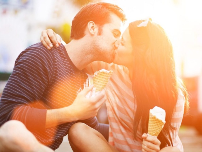 couple kissing and eating ice cream