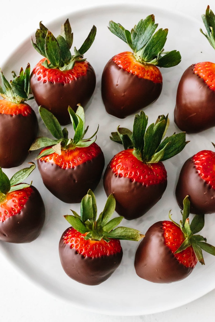 love and romance strawberries dipped in chocolate on a white plate