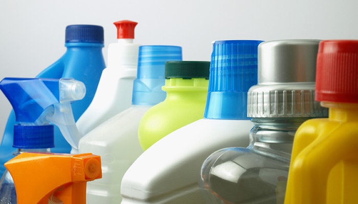 cleaning detergents and products different size and color bottles arranged in a row