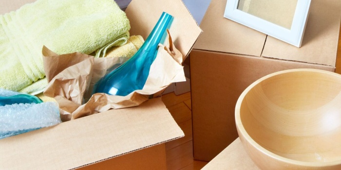 clear the clutter different objects in cardboard boxes bottle and a bowl