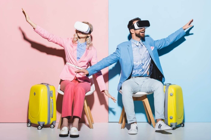 travelling virtually in a couple man and woman in bright clothes with yellow suitcases and hands in the air