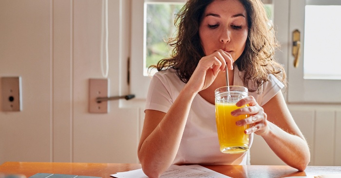 woman drinking a juice