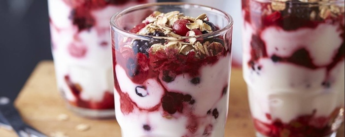 yoghurt with berries in a cup with oats on top