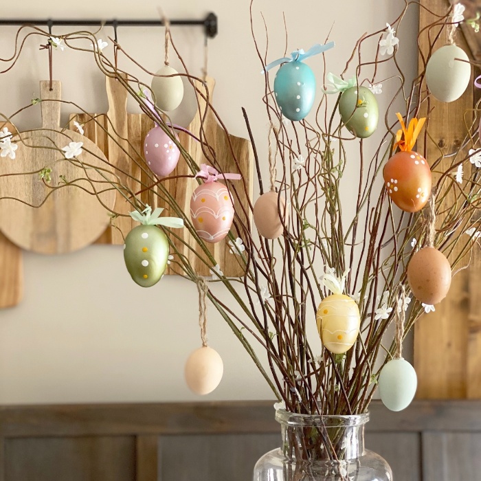 easter tree with colorful hollow eggs in a kitchen in a large vase