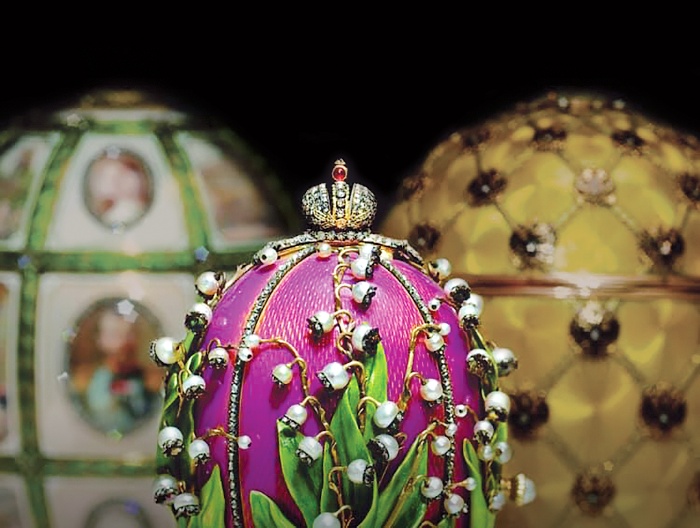 three faberge eggs on a dark background with precious stones and pearls