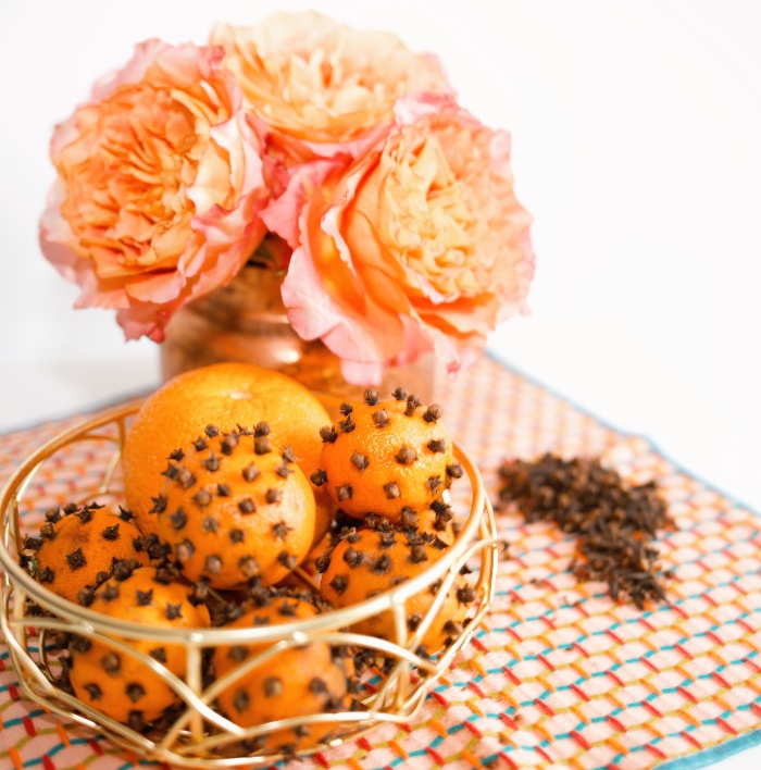 natural aromas oranges and cloves on a table with fresh flowers