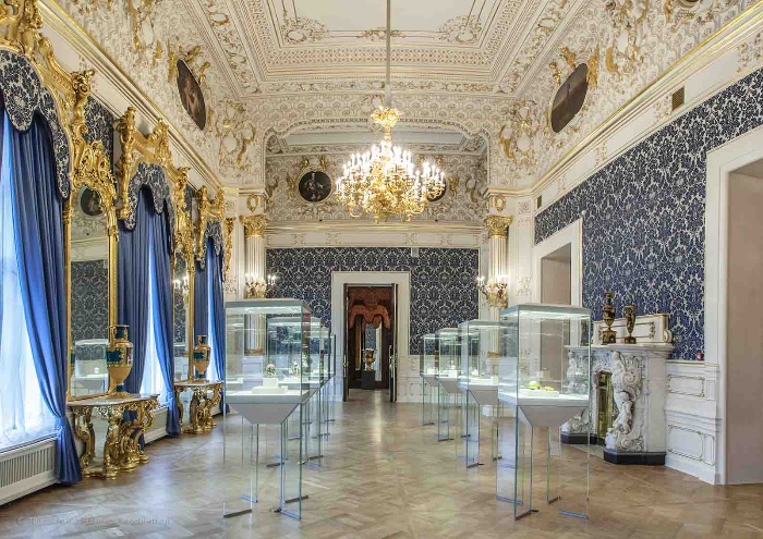 opulent blue room in a palace with a faberge egg display 