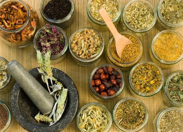 power of herbs different dry herbs in jars on a table