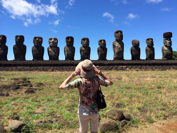 tourism easter islands woman with a sun hat looking at the stone statues 