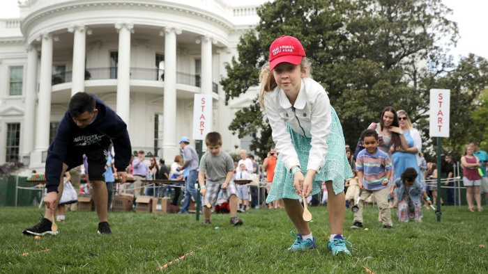 ester egg roll in front of the white house children pushing eggs on the lawn