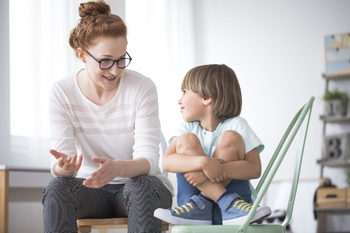 mother speaking to her little boy teaching and explaining