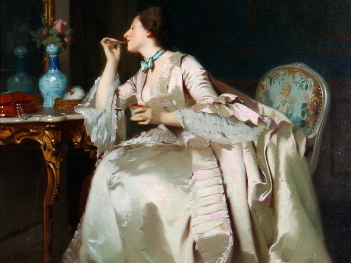 victorian england woman in front of a mirror applying make up with a large dress