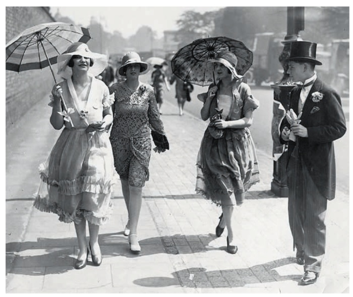 women beauty women in dresses walking with parasoles and hats on a street 