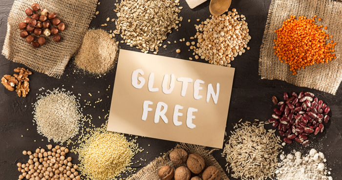 gluten free sign surrounded by rice beans wheat lentils and nuts