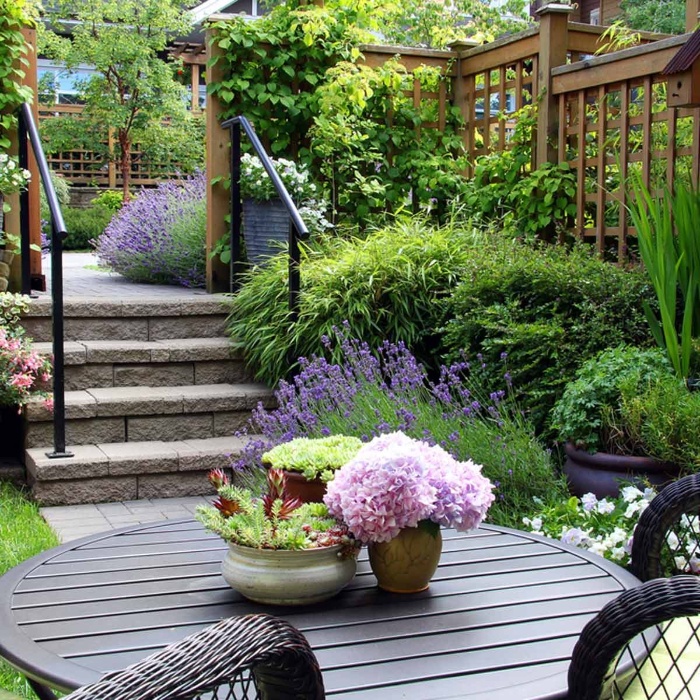 backyard garden with flowers rattan chairs lavender bushes