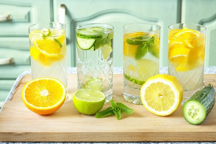 best hydration glasses of water with pieces of lemon lime mint and cucumber