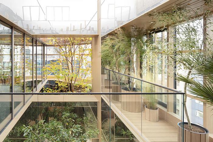 biophilic design glass building interior with living plants inside