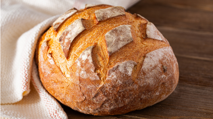 homemade fresh bread on a table covered with a white cloth