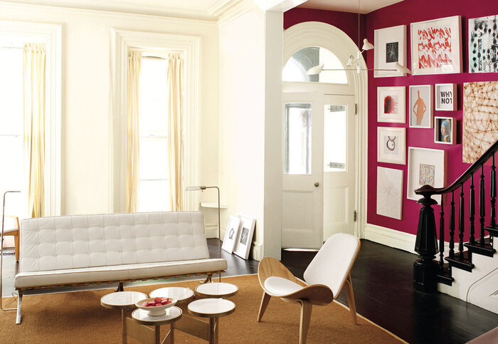 color choices in the interior white space with a bright lilac wall with art modern furniture