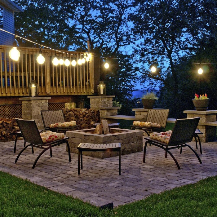 eye catching lamps bulbs on a porch with four chairs around a fire pit