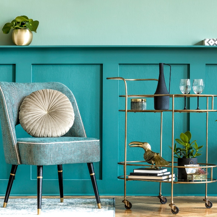 home decor in turquoise color chair and a golden serving stand