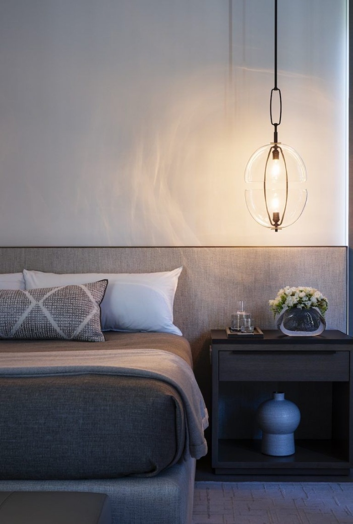 modern light over a night stand in a minimalist bedroom