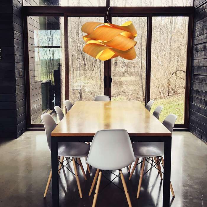 modern lighting fixture in a dining room with large window