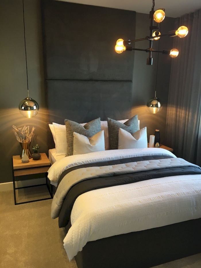 modern metal lights in a dark bedroom over the bed