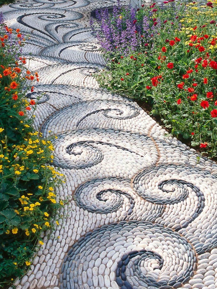 blue and white mosaic walkways wave pattern with flowers on the two sides