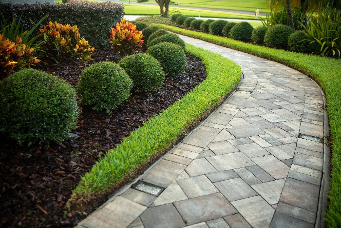 paver patios with grey tiles and green surroundings