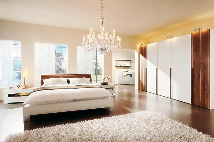 pendant light in a large light and spacious bedroom with a white carpet and large warderob