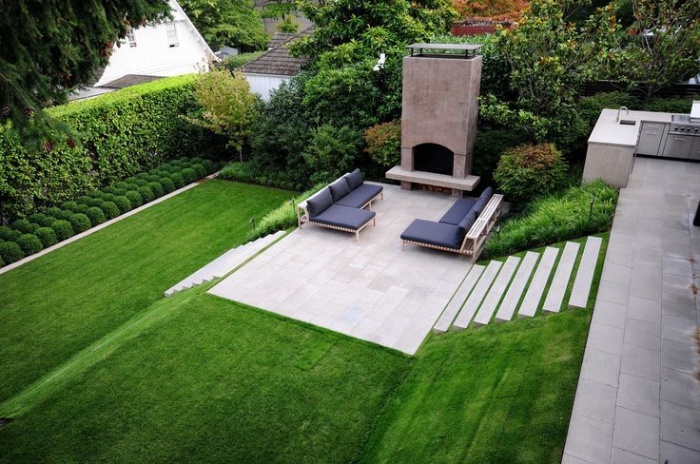 sloped yard with green grass and stairs