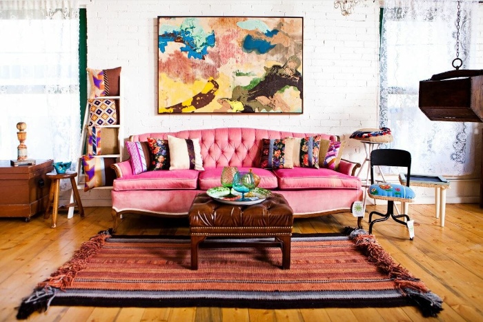 vintage boho interior in bright colors artwork pink couch and white wall